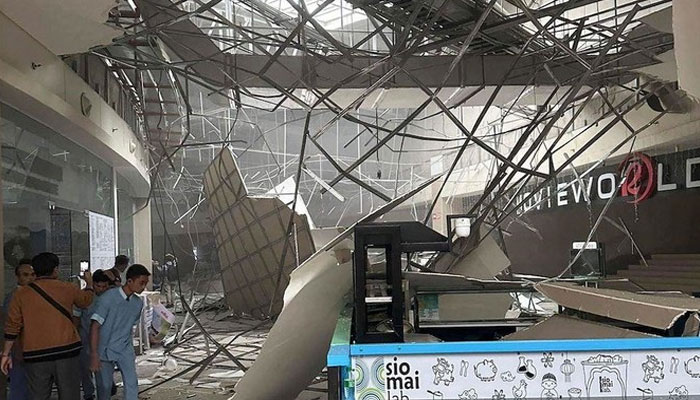 The image shows a collapsed ceiling inside a shopping mall in General Santos City, less than 100 kilometers from the epicenter. — AFP File