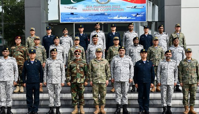 The image shows a group photo after the bilateral exercise Sea Guardian-2023 between Pakistan Navy and Peoples Liberation Army (Navy) of China held at Pakistan Navy Dockyard, Karachi. — Radio Pakistan