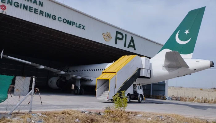 This picture released on February 9, 2023, shows Pakistan International Airlines (PIA) aircraft parked inside a shade in Nur Khan Engineering Complex in Islamabad. — X/@PIA