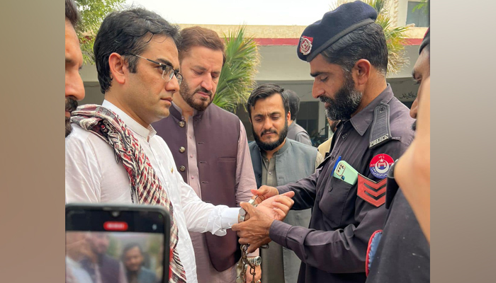Former provincial minister Kamran Bangash can be seen being handcuffed by the police in this image released on October 31, 2023. — Facebook/Kamran Bangash