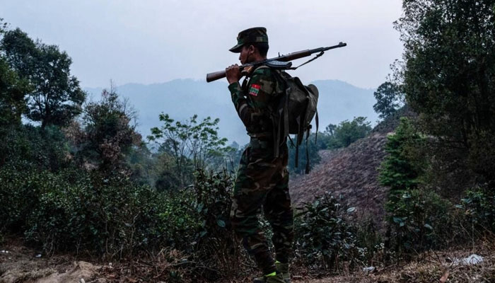 A member of the ethnic rebel group Taang National Liberation Army (TNLA) patrols near the Namhsan Township in Myanmar in March 2023. —AFP File