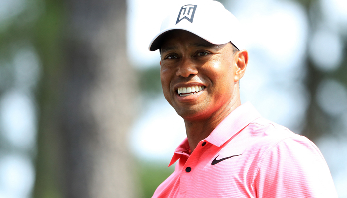 Tiger Woods of the US smiles on the fourth tee during a practice round prior to the start of the 2018 Masters Tournament at Augusta National Golf Club in Augusta, Georgia, on April 2, 2018. — AFP