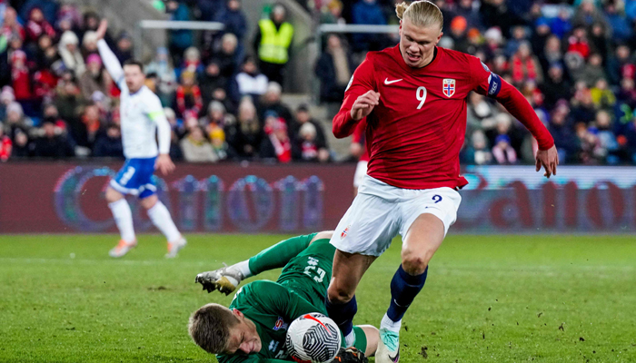 Faroes goalkeeper Bardur a Reynatrod and Norways forward Erling Haaland vie for the ball during the football-friendly match between Norway and Faroe Islands in Oslo, Norway, on November 16, 2023. — AFP
