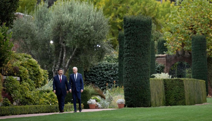 US President Joe Biden walks with Chinese President Xi Jinping as they meet at Filoli Estate during the APEC Leaders week in Woodside, California, on November 15, 2023. — AFP