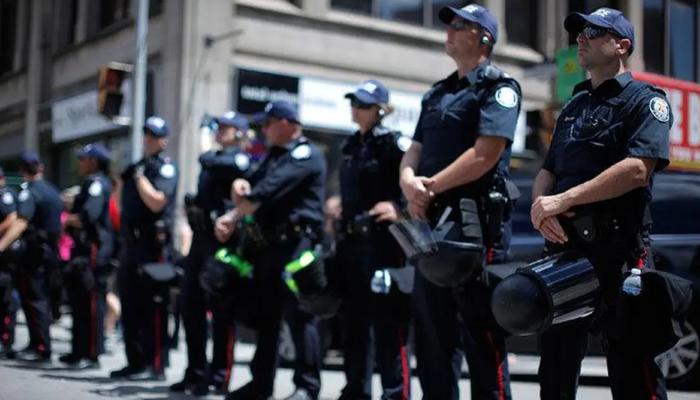 Canadian police officials standing alert. — AFP/File