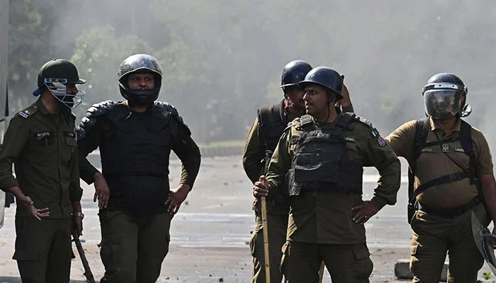 Policemen stand guard after a protest in Lahore on May 11, 2023. — AFP