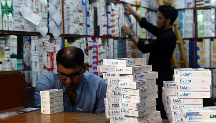 Pharmacists arrange medicines at a pharmacy shop in Peshawar on September 1, 2021. —AFP/File