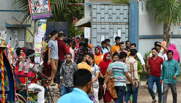 Garments workers walk off a factory at lunch break in Ashulia on November 8, 2023, a day after Minimum Wage Board authority declared the minimum wage of 12,500 taka ($113) for garment workers. — AFP File