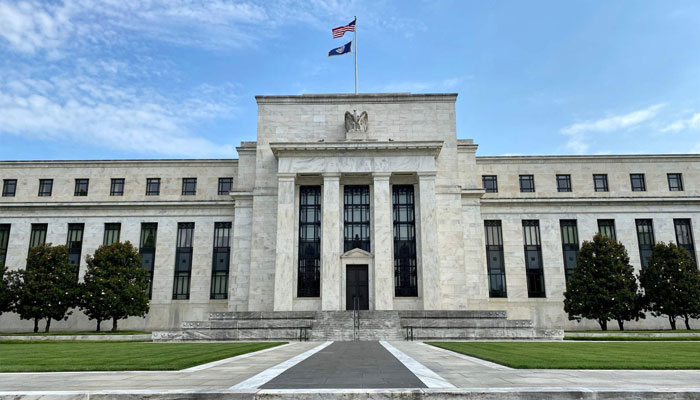 The U.S. and Federal Reserve flags fly on top of the Federal Reserve Board building in Washington, D.C., the U.S., July 1, 2020. — AFP