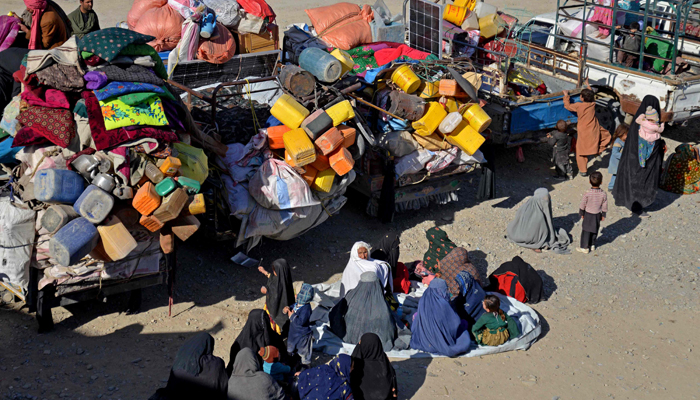 Afghan refugees sit beside their belongings at a registration centre, upon their arrival from Pakistan near the Afghanistan-Pakistan border in Kandahar on November 20, 2023. — AFP