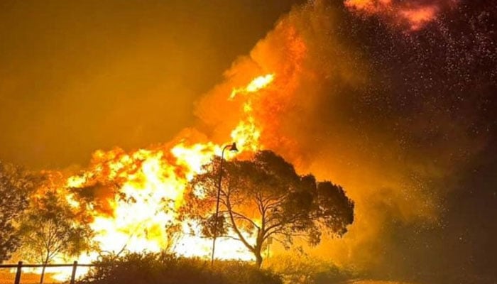Flames of a bushfire burning north of the city of Perth. — AFP/File