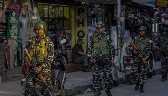 Indian paramilitary soldiers patrol at a busy market in Srinagar, Indian controlled Kashmir on Aug 1, 2023.  — AFP