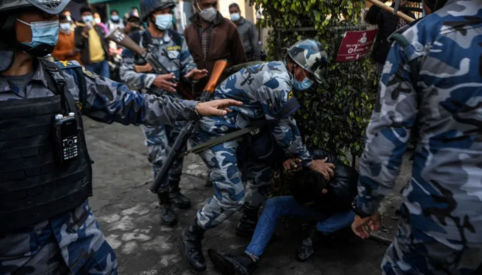 Police personnel detain a demonstrator during a protest against the proposed grant. — AFP File
