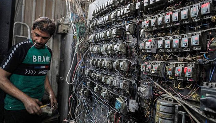 A technician monitors an electric switchboard in Bagdad, on June 30, 2021. — AFP
