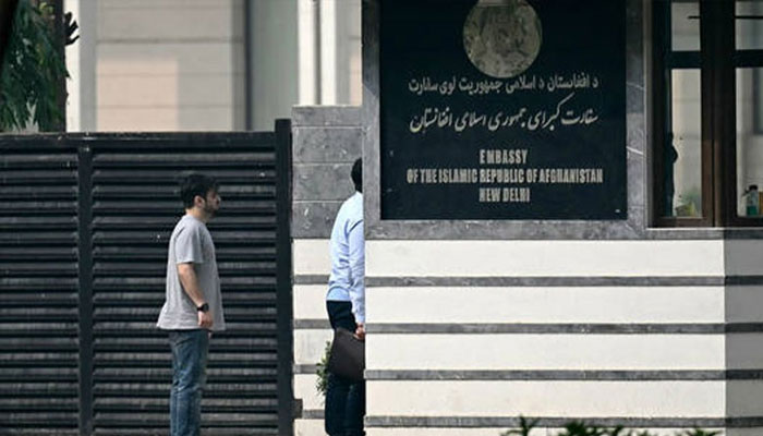 Visitors stand outside the Afghanistan embassy in New Delhi on November 24, 2023, following the embassys announcement to close their operations permanently. — AFP