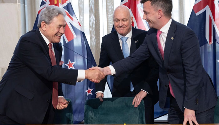 New Zealands incoming prime minister Christopher Luxon (C) has formed a three-party coalition government with New Zealand First leader Winston Peters (L) and ACT leader David Seymour (R). — AFP