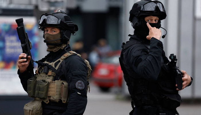 Officers from the RAID tactical unit of the French National Police patrol a street in Lille. — AFP/File