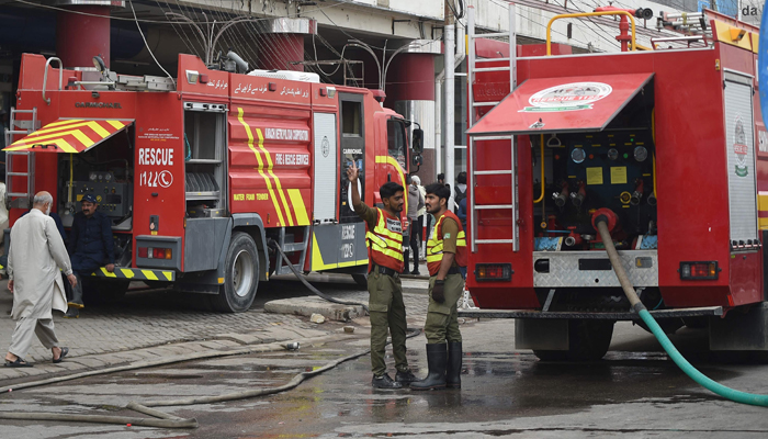 Firefighters douse the fire at a shopping mall in Karachi on November 25, 2023