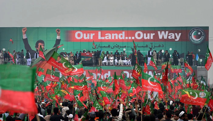 Pakistan Tehreek-e-Insaaf (PTI) activists wave party flags during a rally in Peshawar. — AFP/File