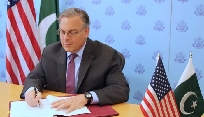 US Ambassador Donald Blome signs the second US-Pakistan bilateral agreement on September 30, 2022. — APP