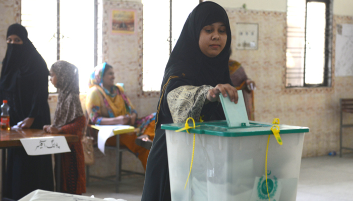 A voter casts her ballot in a by-election in Lahore. — AFP/File