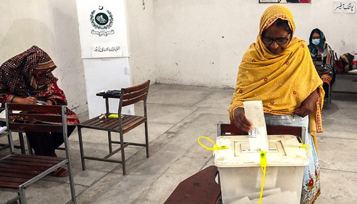 Voters cast their ballot at a polling station during the by-election in Punjab in Lahore. — AFP/File