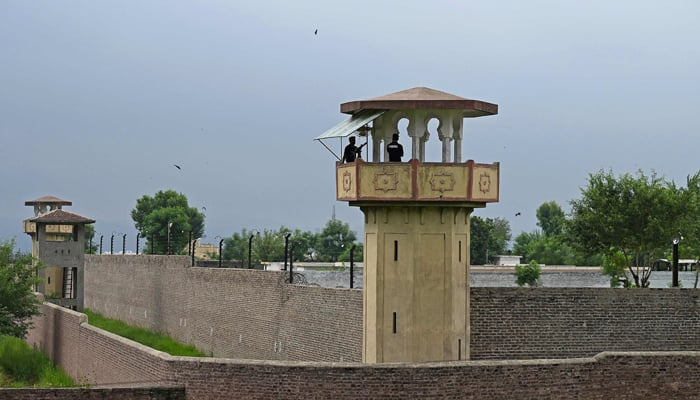 Policemen stand at a watch tower of the Attock jail. — AFP/File