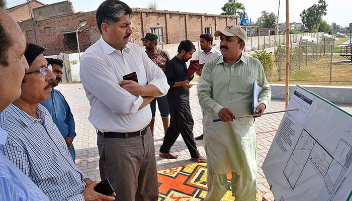 DG Sports and Youth Affairs Punjab Dr. Asif Tufail being briefed about the construction work of Tehsil Sports Complex in Sargodha Division. APP/File