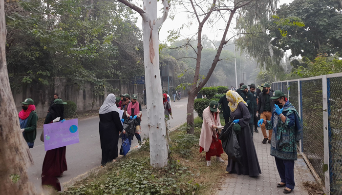 Students of the University of Punjab can be seen collecting plastic waste on the occasion of an awareness seminar and cleaning activity regarding plastic-based materials on November 27, 2023. — Facebook/Shinawar Waseem Ali