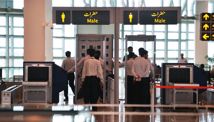 Airport staff walk through security at the Islamabad International Airport. — AFP/File