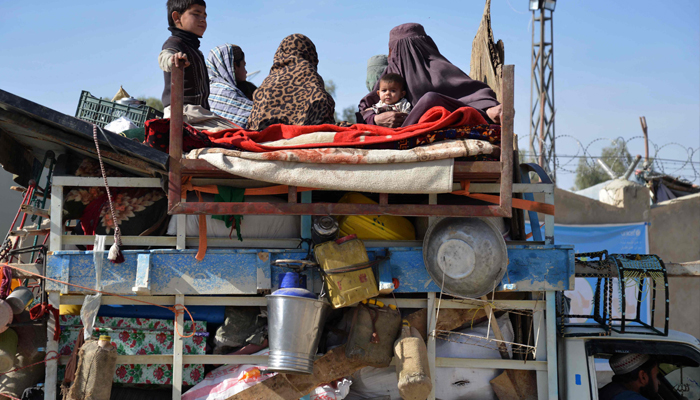 Afghan refugees with their belongings arrive on vehicles from Pakistan at a registration centre near Spin Boldak Kandahar on November 28, 2023. — AFP