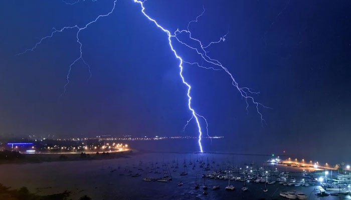 A lightning bolt strikes near the Uruguayan Yacht Club during a thunderstorm in Montevideo in November 2021. — AFP