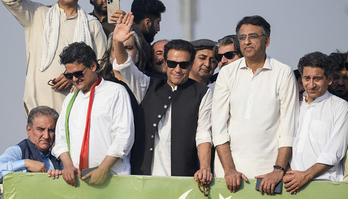 Former prime minister Imran Khan (C) waves at his party supporters during a rally in Islamabad on May 26, 2022. — AFP