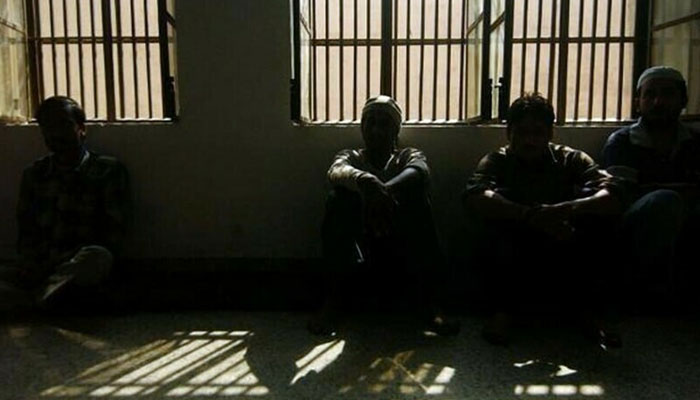 In this picture, prisoners sit in a dark jail. — AFP/File
