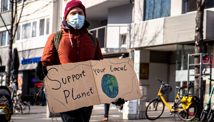 This representational image shows a climate activist holding a placard. — Unsplash/File