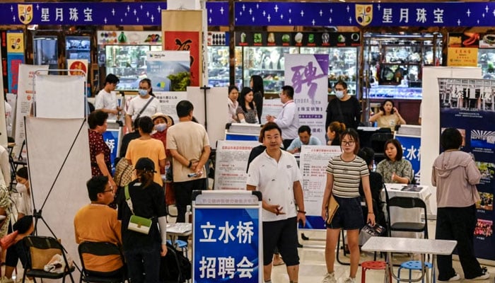 This photo taken on Aug. 19, 2023, shows people attending a job fair in Beijing.—AFP File