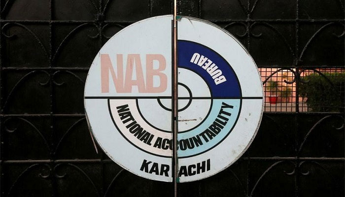 A logo of the National Accountability Bureau (NAB) is seen on the main entrance of their office in Karachi, Pakistan. — APP File