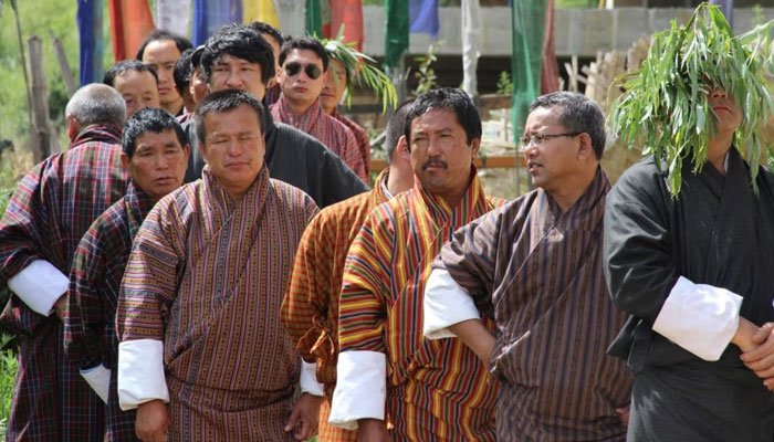 In this photograph taken on July 13, 2013, Bhutanese men wait in line to cast their votes at a polling station in Thimphu. —AFP File