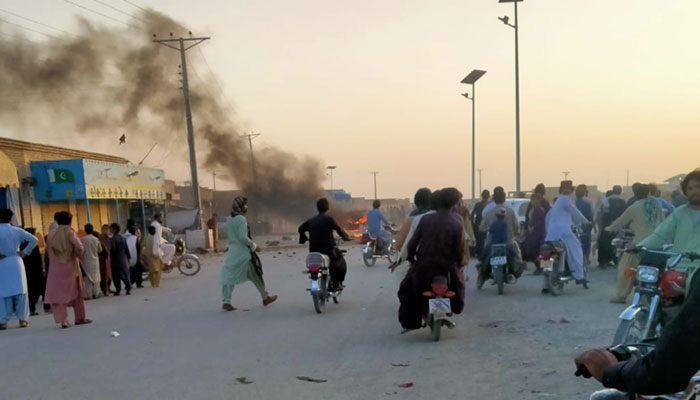 People gather around the site of the roadside bomb blast in Chaghi bazaar on October 4, 2023. — The News/File