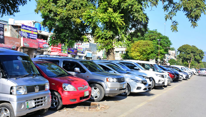 A view of the rental and for sale cars, parked by dealers on footpath outside their shops in Islamabad. — Online