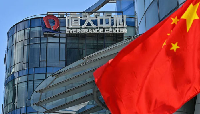 A Chinese flag waves in front of the Evergrande Center building in Shanghai, China, on Sept. 22. —AFP
