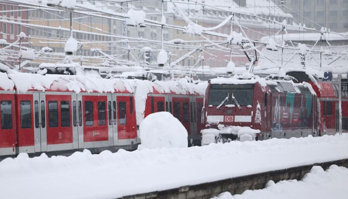 Snow-covered trains are parked at a standstill at Munich Central Station in Munich, Germany, on Saturday after heavy snowfall caused chaos across the region, including the suspension of flight operations at Munich Airport. —EPA-EFE