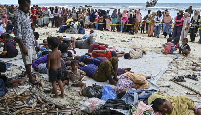 A boat carrying more than 100 Rohingya refugees lands on Sabang island in Indonesias westernmost Aceh province. —AFP File