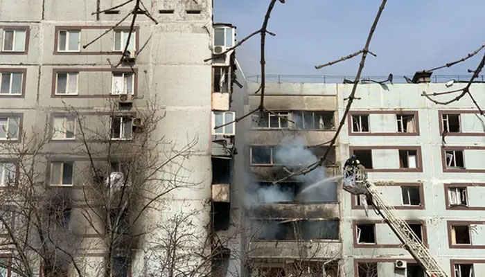 Firefighters work on a fire at a damaged building after an air strike in the city of Zaporizhzhia on March 22, 2023, amid the Russian invasion of Ukraine. - AFP
