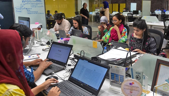 People work at their stations at an incubation centre in Lahore. — AFP/File