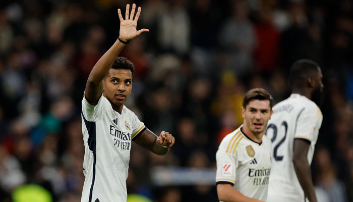 Real Madrids Rodrygo celebrates after scoring his teams second goal during the Spanish league football match between Real Madrid CF and Granada FC at the Santiago Bernabeu stadium in Madrid on December 1, 2023. — AFP