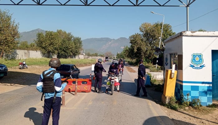 Police personnel of the Islamabad Police check civilians at a check post on November 28, 2023. — Facebook/Islamabad Police