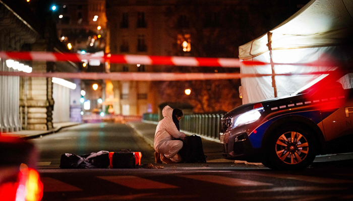 A forensic police officer works at the scene of a stabbing in Paris on December 2, 2023. — AFP