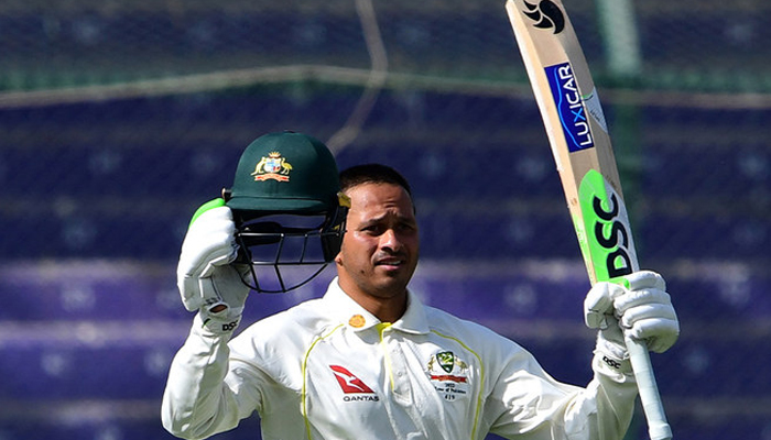 Australias Usman Khawaja celebrates after scoring a century during the first day of the second Test cricket match between Pakistan and Australia at the National Cricket Stadium in Karachi on March 12, 2022. — AFP