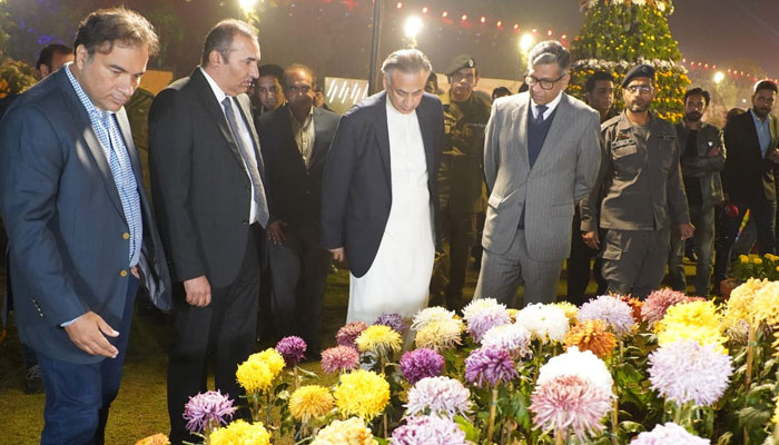 Chief Secretary, Zahid Akhtar Zaman (2nd L) visits stalls during the inauguration of the annual chrysanthemum show organized by the Parks and Horticulture Authority in Jilani Park on December 4, 2023. —Facebook/Parks and Horticulture Authority, Lahore